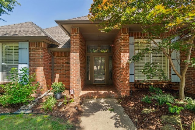 108 N Bradbury Dr, Edmond, OK 73034 - property entrance featuring roof with shingles and brick siding