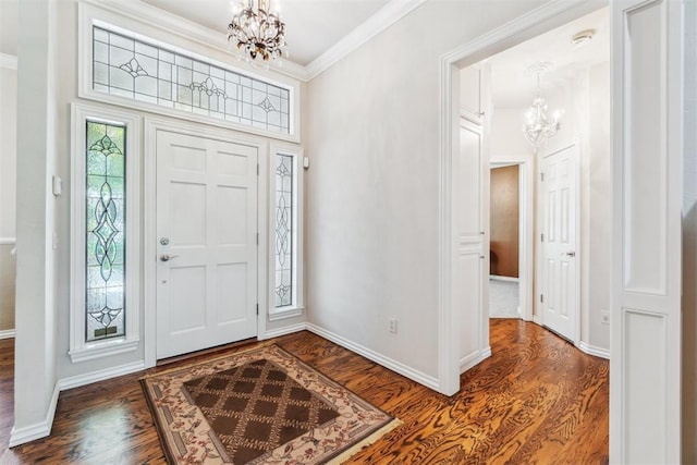 108 N Bradbury Dr, Edmond, OK 73034 - foyer with a chandelier, dark wood-style flooring, and crown molding