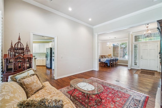 108 N Bradbury Dr, Edmond, OK 73034 - living room with a chandelier, crown molding, wood finished floors, recessed lighting, and ornate columns
