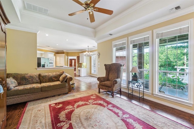 108 N Bradbury Dr, Edmond, OK 73034 - living room featuring a chandelier, wood finished floors, ornamental molding, and ceiling fan