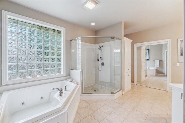 108 N Bradbury Dr, Edmond, OK 73034 - full bathroom with a shower stall, a jetted tub, and tile patterned floors