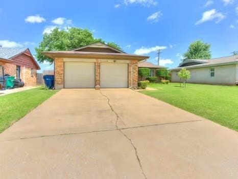 1329 SW 77th Ter, Oklahoma City, OK 73159 - view of front of home with a front lawn, driveway, and an attached garage