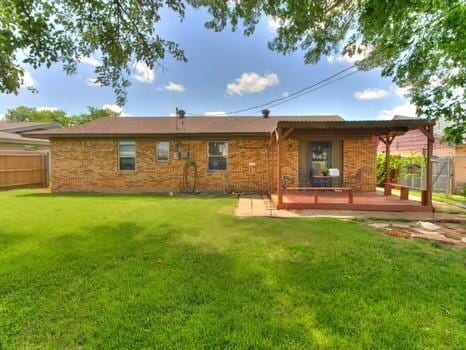 1329 SW 77th Ter, Oklahoma City, OK 73159 - back of property with a wooden deck