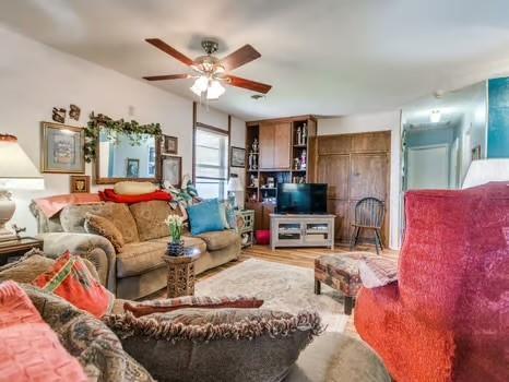 1329 SW 77th Ter, Oklahoma City, OK 73159 - living room with ceiling fan and wood finished floors