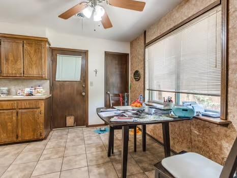 1329 SW 77th Ter, Oklahoma City, OK 73159 - dining area with a ceiling fan and light tile patterned floors