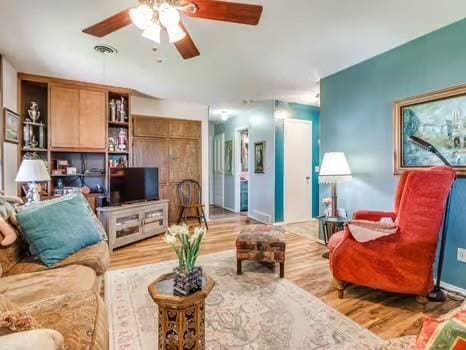 1329 SW 77th Ter, Oklahoma City, OK 73159 - living area with a ceiling fan and wood finished floors