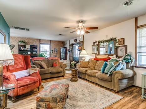 1329 SW 77th Ter, Oklahoma City, OK 73159 - living room with healthy amount of natural light, wood finished floors, and a ceiling fan