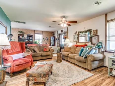 1329 SW 77th Ter, Oklahoma City, OK 73159 - living area with wood finished floors and ceiling fan