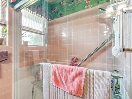 1329 SW 77th Ter, Oklahoma City, OK 73159 - bathroom with a tile shower and tile walls