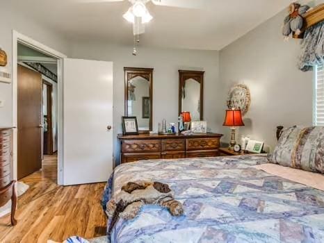 1329 SW 77th Ter, Oklahoma City, OK 73159 - bedroom featuring wood finished floors and a ceiling fan