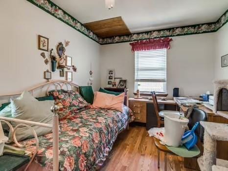 1329 SW 77th Ter, Oklahoma City, OK 73159 - bedroom with wood finished floors and a desk