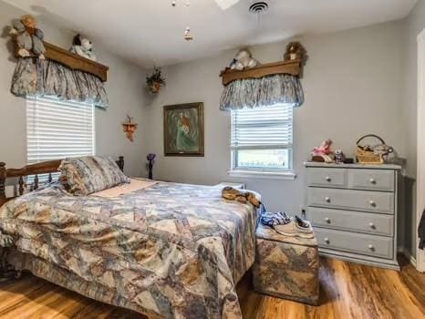 1329 SW 77th Ter, Oklahoma City, OK 73159 - bedroom with wood finished floors and ceiling fan