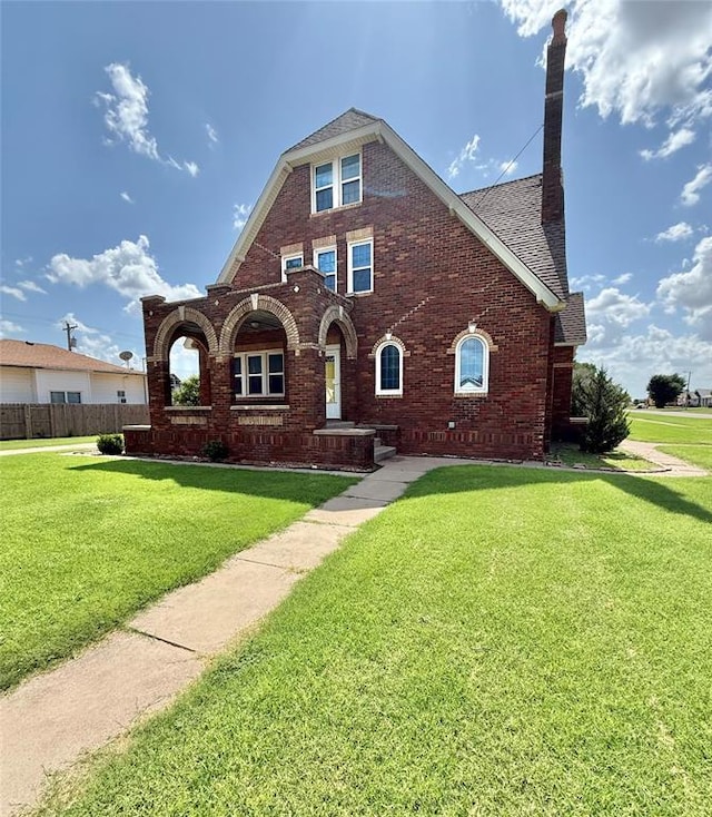 722 E Main St, Sentinel, OK 73664 - view of front facade featuring a front lawn, brick siding, and roof with shingles