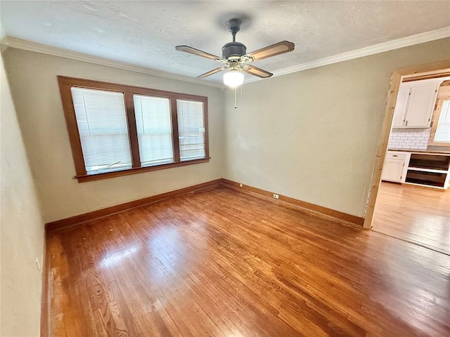 722 E Main St, Sentinel, OK 73664 - spare room featuring light wood finished floors, crown molding, and ceiling fan