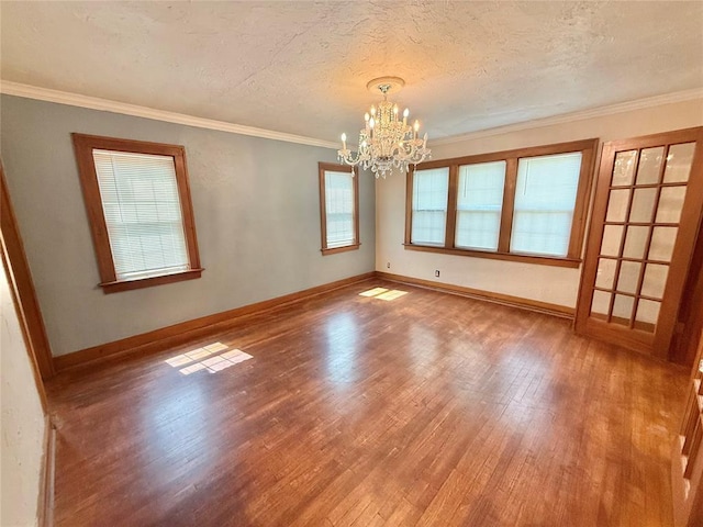 722 E Main St, Sentinel, OK 73664 - empty room featuring wood finished floors, a chandelier, a textured ceiling, and crown molding