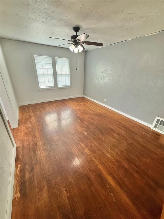 722 E Main St, Sentinel, OK 73664 - spare room featuring a ceiling fan, wood finished floors, and a textured ceiling