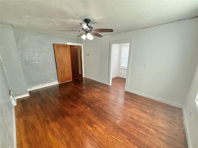 722 E Main St, Sentinel, OK 73664 - spare room with wood finished floors, ceiling fan, and a textured ceiling