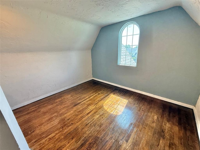 722 E Main St, Sentinel, OK 73664 - bonus room featuring wood-type flooring and vaulted ceiling
