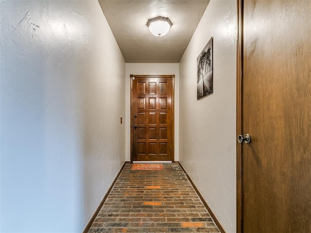 2228 Butternut Pl, Edmond, OK 73013 - doorway featuring brick floors and baseboards
