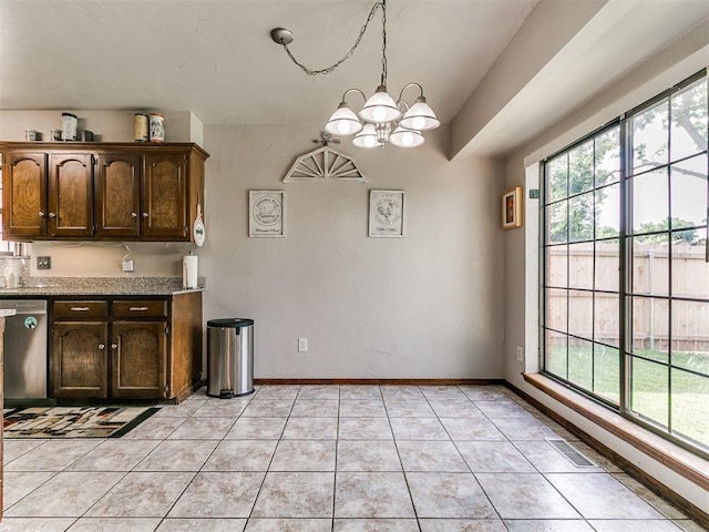 2228 Butternut Pl, Edmond, OK 73013 - kitchen with stainless steel dishwasher, a chandelier, light tile patterned floors, and dark brown cabinets