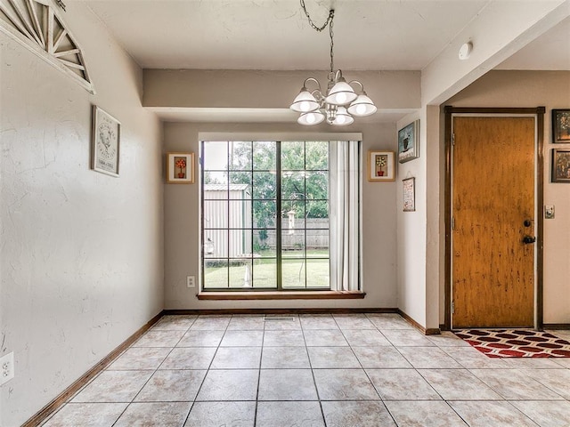 2228 Butternut Pl, Edmond, OK 73013 - unfurnished dining area with a chandelier and light tile patterned floors