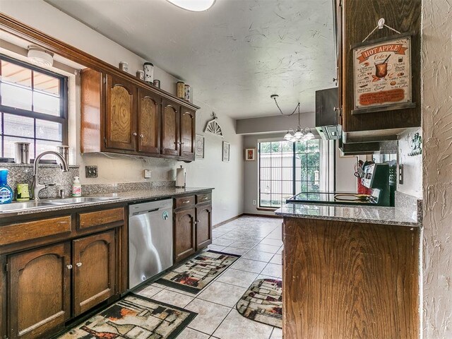 2228 Butternut Pl, Edmond, OK 73013 - kitchen with dishwasher, light tile patterned floors, stove, and dark brown cabinetry