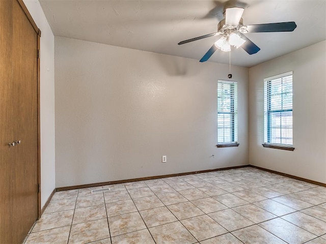 2228 Butternut Pl, Edmond, OK 73013 - empty room featuring light tile patterned floors and a ceiling fan
