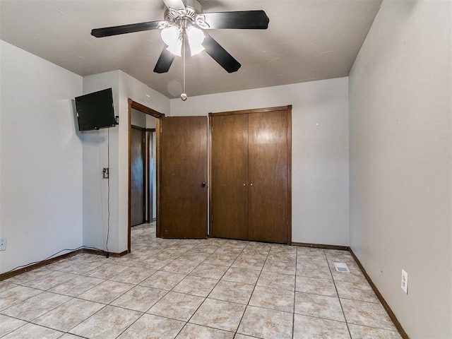 2228 Butternut Pl, Edmond, OK 73013 - unfurnished bedroom featuring a ceiling fan, light tile patterned flooring, and a closet