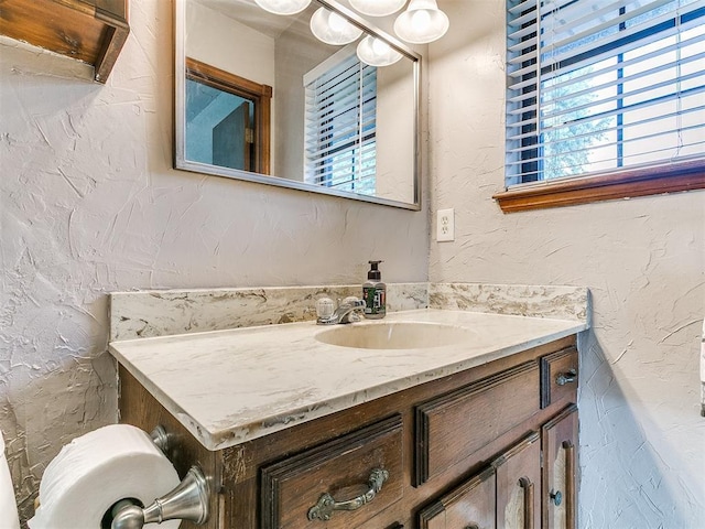 2228 Butternut Pl, Edmond, OK 73013 - bathroom with vanity and a textured wall