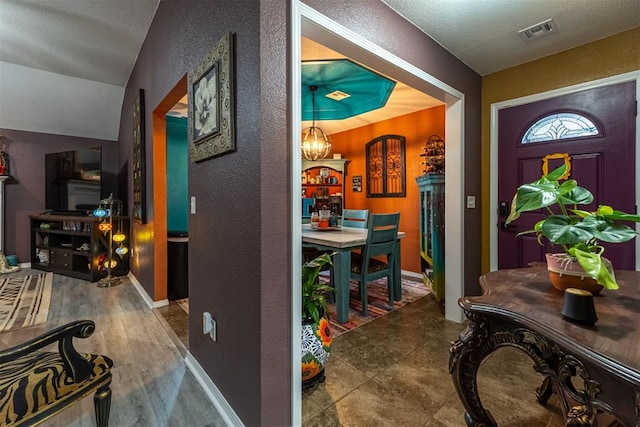 1408 Eagle Dr, Moore, OK 73160 - entryway featuring a textured wall and a chandelier