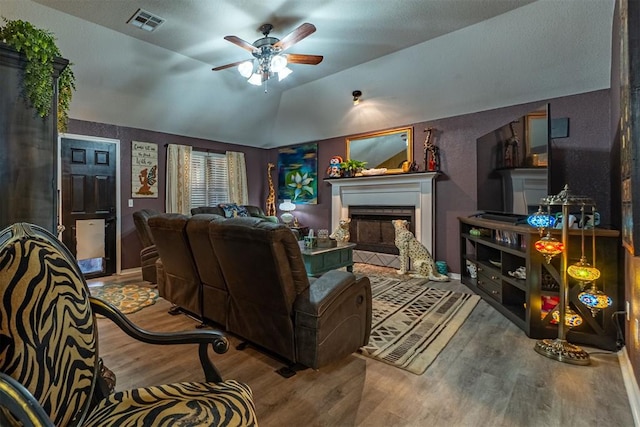 1408 Eagle Dr, Moore, OK 73160 - living room with wood finished floors, ceiling fan, vaulted ceiling, and a fireplace