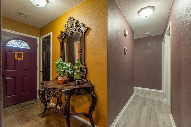 1408 Eagle Dr, Moore, OK 73160 - foyer entrance with a textured wall and a textured ceiling