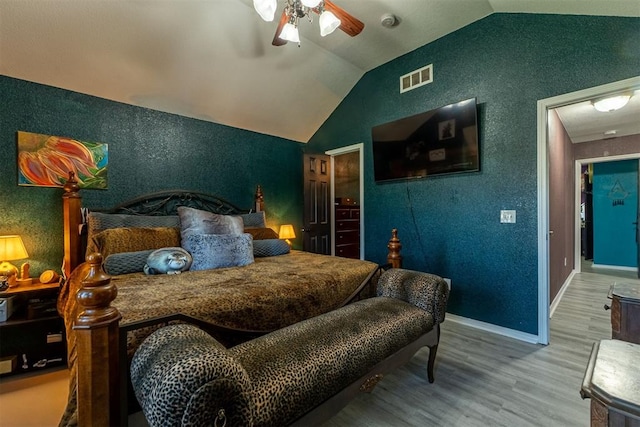 1408 Eagle Dr, Moore, OK 73160 - bedroom featuring vaulted ceiling, wood finished floors, a textured wall, and a ceiling fan