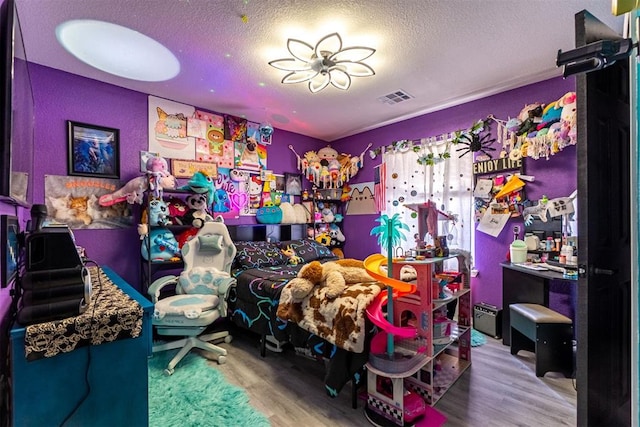 1408 Eagle Dr, Moore, OK 73160 - bedroom featuring wood finished floors and a textured ceiling