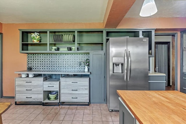 2122 Edinburg Dr, Yukon, OK 73099 - kitchen featuring stainless steel refrigerator with ice dispenser, open shelves, light tile patterned floors, and butcher block counters