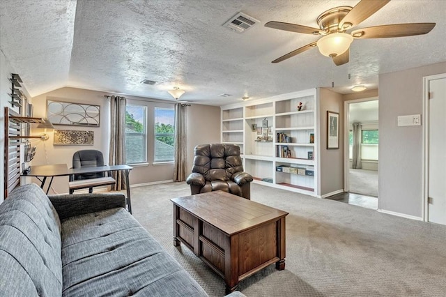 2122 Edinburg Dr, Yukon, OK 73099 - carpeted living area featuring a textured ceiling, a desk, plenty of natural light, and a ceiling fan