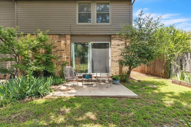 2122 Edinburg Dr, Yukon, OK 73099 - back of house with brick siding and a patio area
