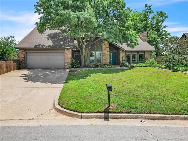 2122 Edinburg Dr, Yukon, OK 73099 - mid-century modern home with driveway, brick siding, a garage, and a chimney