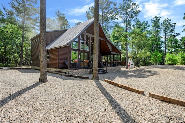 36 Spruce Ct, Broken Bow, OK 74728 - view of side of property featuring log veneer siding and a metal roof