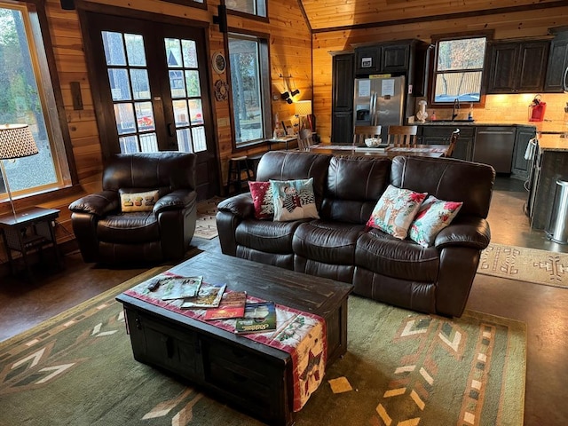 36 Spruce Ct, Broken Bow, OK 74728 - living area featuring plenty of natural light, wood walls, and vaulted ceiling