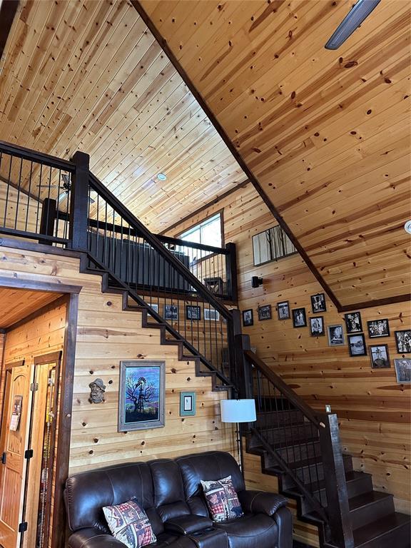 36 Spruce Ct, Broken Bow, OK 74728 - living room with wood walls, stairway, a towering ceiling, and wood ceiling