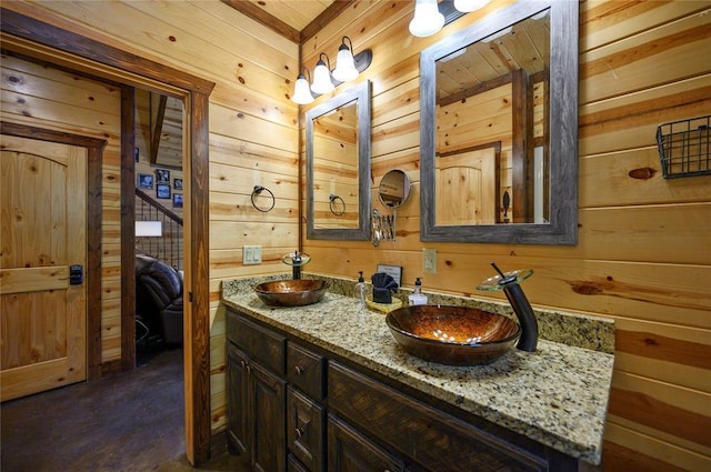 36 Spruce Ct, Broken Bow, OK 74728 - ensuite bathroom with wood walls, double vanity, and finished concrete floors