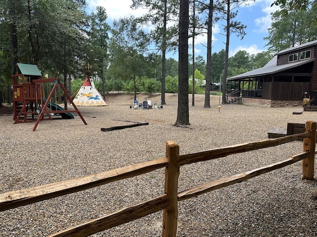 36 Spruce Ct, Broken Bow, OK 74728 - view of yard with a playground and view of wooded area