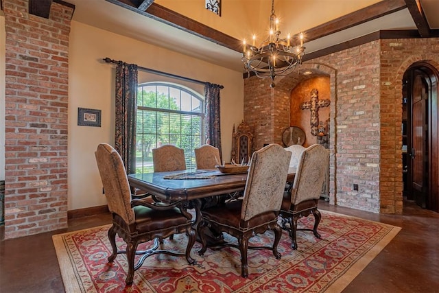 1505 SW 113th Pl, Oklahoma City, OK 73170 - dining space with finished concrete flooring, a chandelier, arched walkways, brick wall, and a high ceiling