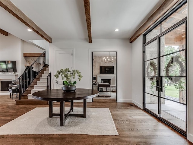 2917 Piazza Ct, Arcadia, OK 73007 - foyer featuring beamed ceiling, stairs, a fireplace, wood finished floors, and recessed lighting