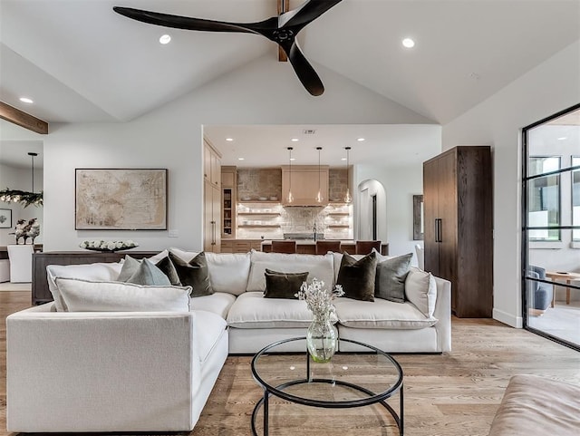 2917 Piazza Ct, Arcadia, OK 73007 - living room featuring a ceiling fan, high vaulted ceiling, arched walkways, light wood-style floors, and recessed lighting