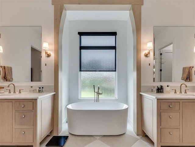 2917 Piazza Ct, Arcadia, OK 73007 - bathroom with two vanities, a freestanding bath, and tile patterned floors