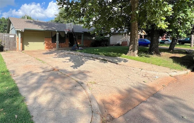 6338 Norman Rd, Warr Acres, OK 73122 - view of front of home featuring an attached garage, brick siding, driveway, and a shingled roof
