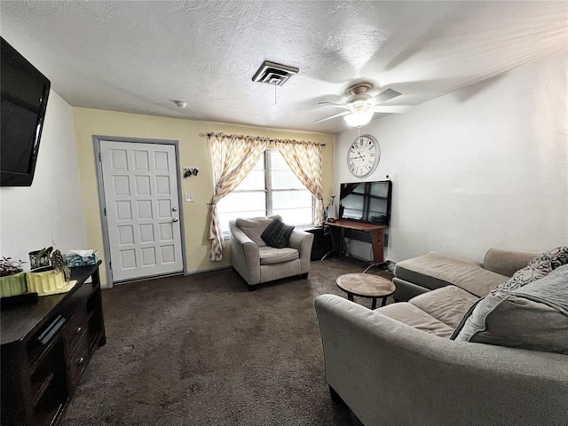 6338 Norman Rd, Warr Acres, OK 73122 - living area featuring ceiling fan, dark colored carpet, and a textured ceiling