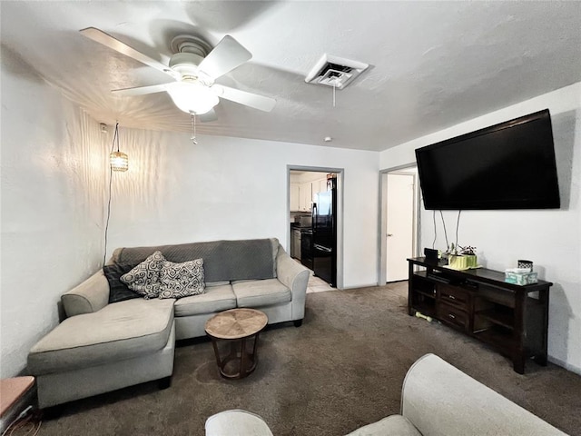 6338 Norman Rd, Warr Acres, OK 73122 - living area with carpet floors and ceiling fan